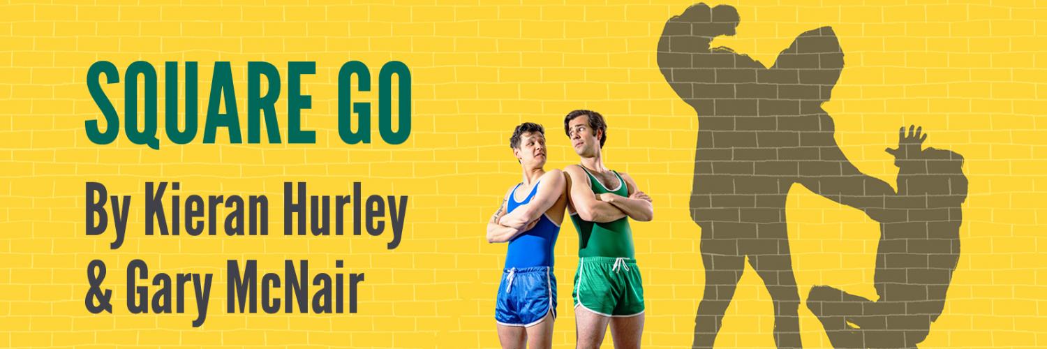 Square Go by Kieran Hurly & Gary McNair; Two boys in wrestling singlets stand in front of a yellow wall in wresting singlets with their arms crossed. Their shadows are a bully with his fist pulled back to swing at the other.