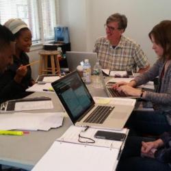 Cast members for <em>The Swallowing Dark</em> along with director Claire Moyer and dialect coach Len Kelly work on the show.