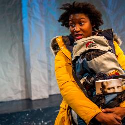 Satchel Williams holding her pack in a production image for A Hundred Words for Snow. Photo: Ashley Smith of Wide Eyed Studios.