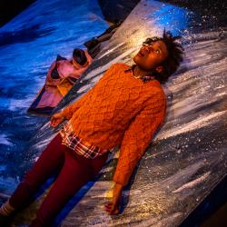 Satchel Williams on lying and looking to the sky in a production image for A Hundred Words for Snow. Photo: Ashley Smith of Wide Eyed Studios.