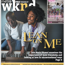 The cover of Metro Philly wknd. Two Back men sit at a piano, the man on the left looks at his hands, while the man on the right looks upwards with a smile. The title says "Lean on Me: Inis Nua's Hymn examines the importance of male friendship and looking at love in unconventional ways"