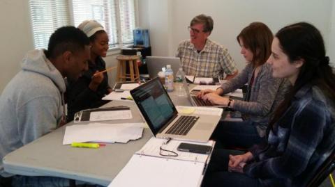 Cast members for <em>The Swallowing Dark</em> along with director Claire Moyer and dialect coach Len Kelly work on the show.