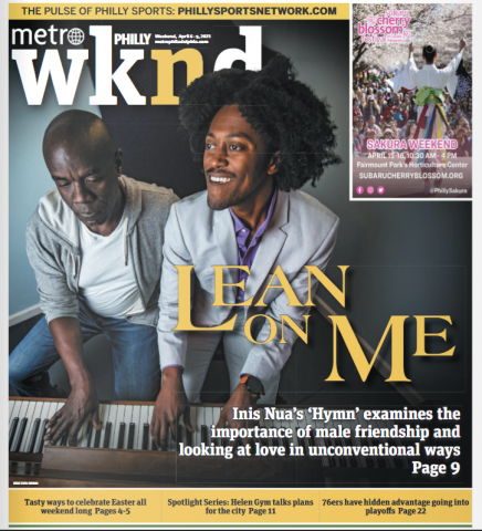 The cover of Metro Philly wknd. Two Back men sit at a piano, the man on the left looks at his hands, while the man on the right looks upwards with a smile. The title says "Lean on Me: Inis Nua's Hymn examines the importance of male friendship and looking at love in unconventional ways"