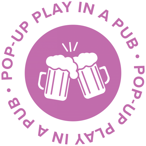 Pop Up Play in a Pub logo. Purple text surrounds a pair of clinking beer mugs inside a purple circle